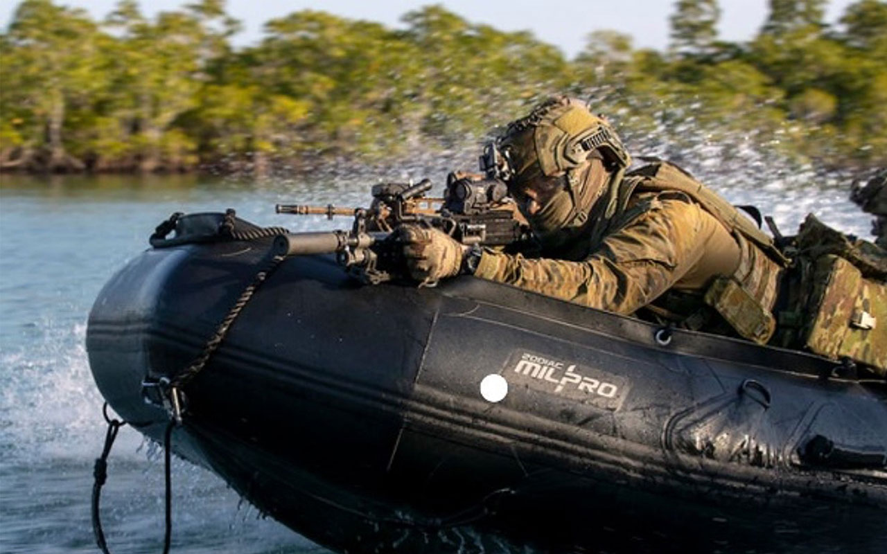 Silentium Defence Soldier in floatation boat aiming a rifle